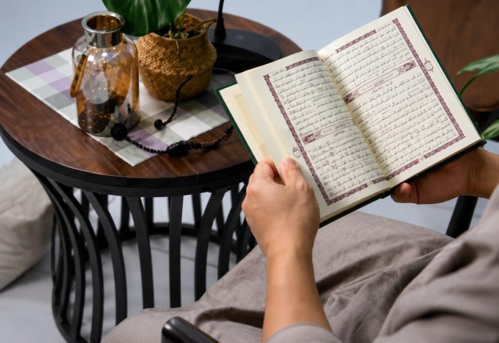 Person reading the Holy Quran at home