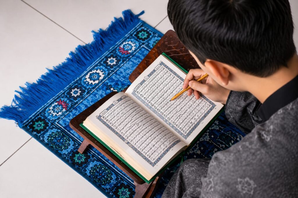 Student learning the Holy Quran with teacher